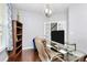Inviting office features hardwood floors, glass desk, and bright natural light at 14125 Derby Farm Ln, Charlotte, NC 28278