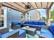 Inviting covered outdoor patio features comfortable seating, stylish decor, and a relaxing ambiance for entertaining at 14125 Derby Farm Ln, Charlotte, NC 28278