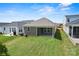 Backyard with a green lawn and patio, providing an outdoor living space with neighborhood views at 1615 Shoals Ave # 158, Belmont, NC 28012