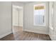Bright bedroom with wood-look floors and a large window, creating an inviting and airy atmosphere at 1615 Shoals Ave # 158, Belmont, NC 28012