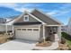 Charming gray home featuring a two-car garage and landscaped front yard at 1615 Shoals Ave # 158, Belmont, NC 28012