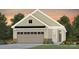 Charming home features a two-car garage, a neutral exterior, brick accents, and manicured landscaping at 1615 Shoals Ave # 158, Belmont, NC 28012