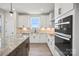 Well-lit kitchen featuring white cabinets, granite counters, and stainless steel appliances at 1615 Shoals Ave # 158, Belmont, NC 28012
