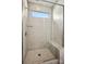 Modern shower with glass door and bench, complemented by neutral tile and a window for natural light at 1615 Shoals Ave # 158, Belmont, NC 28012