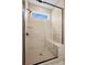 Modern walk-in shower with frameless glass doors, a shower bench, and neutral tile at 1615 Shoals Ave # 158, Belmont, NC 28012