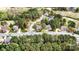 Aerial shot of a home nestled within a golf course community with tree-lined streets and beautifully landscaped yards at 1742 Verdict Ridge Dr, Denver, NC 28037