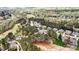 A sprawling overhead view showcases a home and a golf course amidst tall pine trees in a wooded neighborhood at 1742 Verdict Ridge Dr, Denver, NC 28037