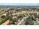 Expansive aerial view of a home and golf course surrounded by lush trees in a residential neighborhood at 1742 Verdict Ridge Dr, Denver, NC 28037