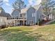 Expansive backyard showcasing a multi-level deck, lush lawn, and mature trees at 1742 Verdict Ridge Dr, Denver, NC 28037