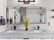 Modern bathroom with marble countertops, dual sinks, and a large framed mirror at 1742 Verdict Ridge Dr, Denver, NC 28037