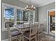 Charming breakfast nook with a rustic table and chairs, bathed in natural light from large windows at 1742 Verdict Ridge Dr, Denver, NC 28037