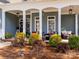 Inviting front porch adorned with decorative wreaths, cozy seating, and elegant pendant lighting at 1742 Verdict Ridge Dr, Denver, NC 28037