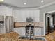 Well-lit kitchen with stainless steel appliances, granite countertops, and classic white cabinetry at 1742 Verdict Ridge Dr, Denver, NC 28037