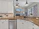 Modern kitchen featuring granite countertops, stainless steel appliances, and an open view to the living room at 1742 Verdict Ridge Dr, Denver, NC 28037