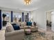 Inviting living room with a cozy sectional couch, bright natural light, and hardwood floors at 1742 Verdict Ridge Dr, Denver, NC 28037