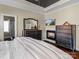 Inviting main bedroom featuring a fireplace, dark wood furnishings, and hardwood floors at 1742 Verdict Ridge Dr, Denver, NC 28037