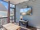Inviting sunroom with a TV, wooden table, and comfortable seating for entertainment and relaxation at 1742 Verdict Ridge Dr, Denver, NC 28037