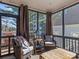 Relaxing sunroom featuring wicker seating, wooden accents, and a view of the surrounding trees at 1742 Verdict Ridge Dr, Denver, NC 28037