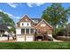 View of the beautiful brick back exterior of the home, with a 2 car garage and a cozy porch at 1754 Sterling Rd, Charlotte, NC 28209