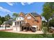 Stunning brick back exterior featuring a spacious deck and access to the meticulously maintained yard at 1754 Sterling Rd, Charlotte, NC 28209