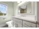 Bright bathroom featuring white cabinetry, quartz counters, and a framed mirror over a sink at 1754 Sterling Rd, Charlotte, NC 28209