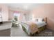 Cozy pink bedroom with a chandelier and lots of natural light at 1754 Sterling Rd, Charlotte, NC 28209
