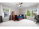 Bright bedroom featuring a twin bed, ceiling fan, plush carpeting and large windows for an airy feel at 1754 Sterling Rd, Charlotte, NC 28209