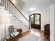 Elegant foyer with hardwood floors, staircase, and grand wooden door at 1754 Sterling Rd, Charlotte, NC 28209