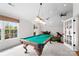 Spacious game room featuring a pool table, vaulted ceiling, and bright natural light at 1754 Sterling Rd, Charlotte, NC 28209