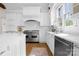 Clean white kitchen featuring an island with a sink, stainless steel appliances, and a subway tile backsplash at 1754 Sterling Rd, Charlotte, NC 28209