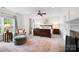 Large main bedroom with windows, a fireplace, seating, and a neutral color palette at 1754 Sterling Rd, Charlotte, NC 28209