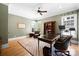 Bright home office with a desk, chair, bookcase, and natural light streaming through multiple windows at 1754 Sterling Rd, Charlotte, NC 28209