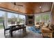 Inviting sun room with wood ceiling, tile floor, a stone fireplace and comfortable seating at 1754 Sterling Rd, Charlotte, NC 28209