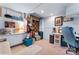 Finished basement with brick details, decor accents, a desk, and carpeted floors at 204 Sylvania Ave, Charlotte, NC 28206