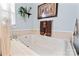 Bathroom showcasing a large soaking tub with beautiful fixtures and brown accent towels at 204 Sylvania Ave, Charlotte, NC 28206