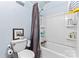 Bathroom features a shower-tub combination with soap shelves and a gray shower curtain at 204 Sylvania Ave, Charlotte, NC 28206