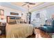 Comfortable bedroom featuring a ceiling fan, a large window, and hardwood floors at 204 Sylvania Ave, Charlotte, NC 28206