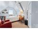 Bedroom featuring natural light, a window unit, wood floors, and a large closet at 204 Sylvania Ave, Charlotte, NC 28206