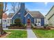 Charming blue brick home with manicured landscaping and inviting front porch at 204 Sylvania Ave, Charlotte, NC 28206