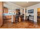 Open kitchen with wood cabinets, island seating, and hardwood floors at 204 Sylvania Ave, Charlotte, NC 28206