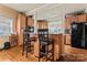 Kitchen with wood cabinets, breakfast bar, and black appliances at 204 Sylvania Ave, Charlotte, NC 28206