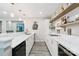 A bar area with light wood and white cabinets, a stainless steel sink, and a built in cook top at 2108 Clarion Dr, Fort Mill, SC 29707