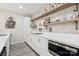 A bar area with light wood and white cabinets, a stainless steel microwave, and open wood shelves at 2108 Clarion Dr, Fort Mill, SC 29707