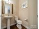 A well-lit half-bathroom with a pedestal sink and updated fixtures at 2108 Clarion Dr, Fort Mill, SC 29707