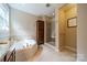 A well lit bathroom features a walk in shower, tub and linen closet at 2108 Clarion Dr, Fort Mill, SC 29707