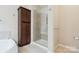 Bright bathroom featuring a glass shower, tub and built-in storage at 2108 Clarion Dr, Fort Mill, SC 29707