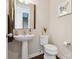 A half bathroom featuring a pedestal sink, toilet, vanity mirror and light fixture at 2108 Clarion Dr, Fort Mill, SC 29707