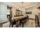 Elegant dining room featuring dark wood floors, long table, and a modern chandelier fixture at 2108 Clarion Dr, Fort Mill, SC 29707