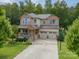 A charming two-story home with a basketball hoop in the driveway and a landscaped yard at 2108 Clarion Dr, Fort Mill, SC 29707