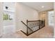 Upstairs hallway with carpeted floors and rod iron railing at 2108 Clarion Dr, Fort Mill, SC 29707
